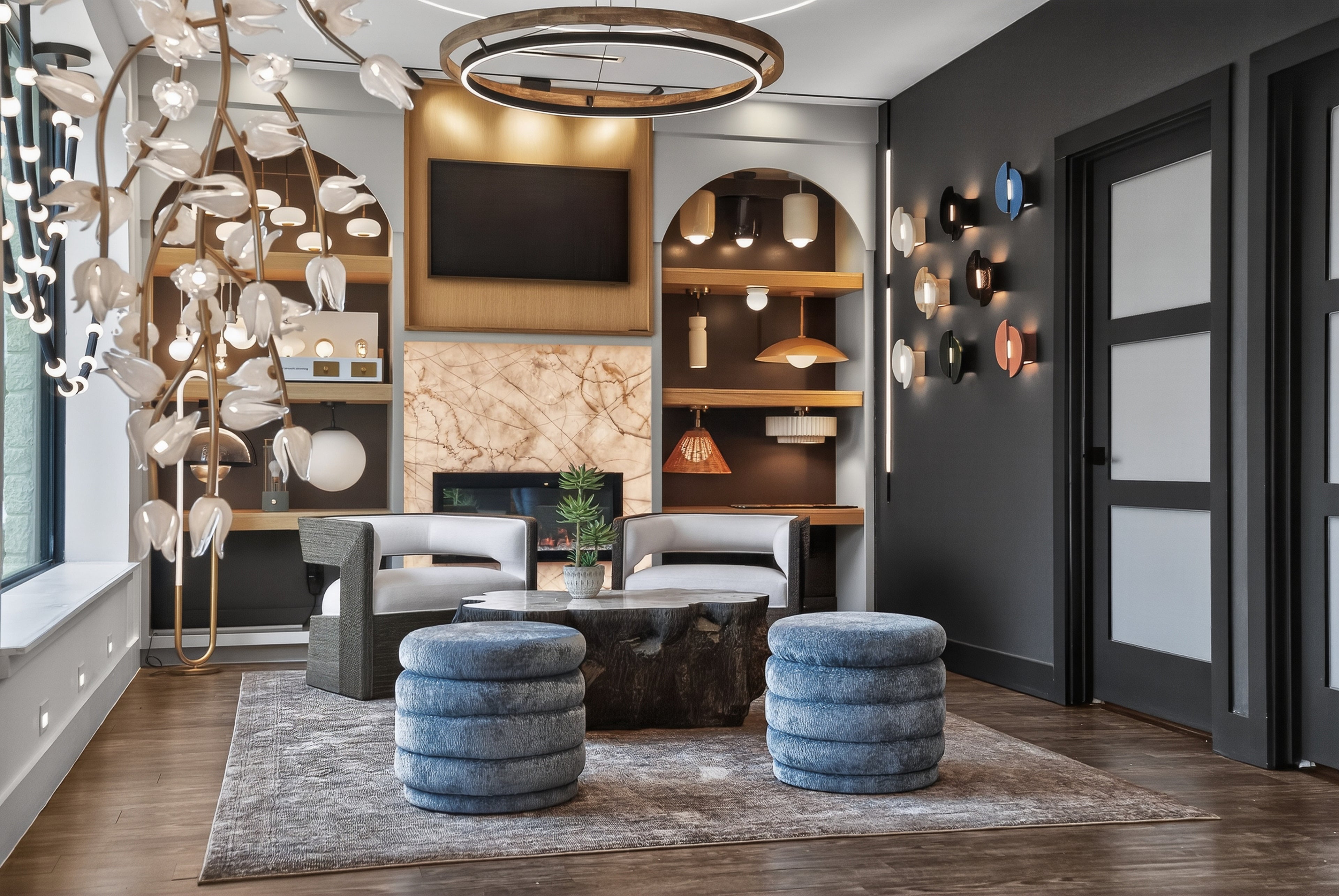 Modern living room with stylish decor, including a TV, shelves, and decorative items.